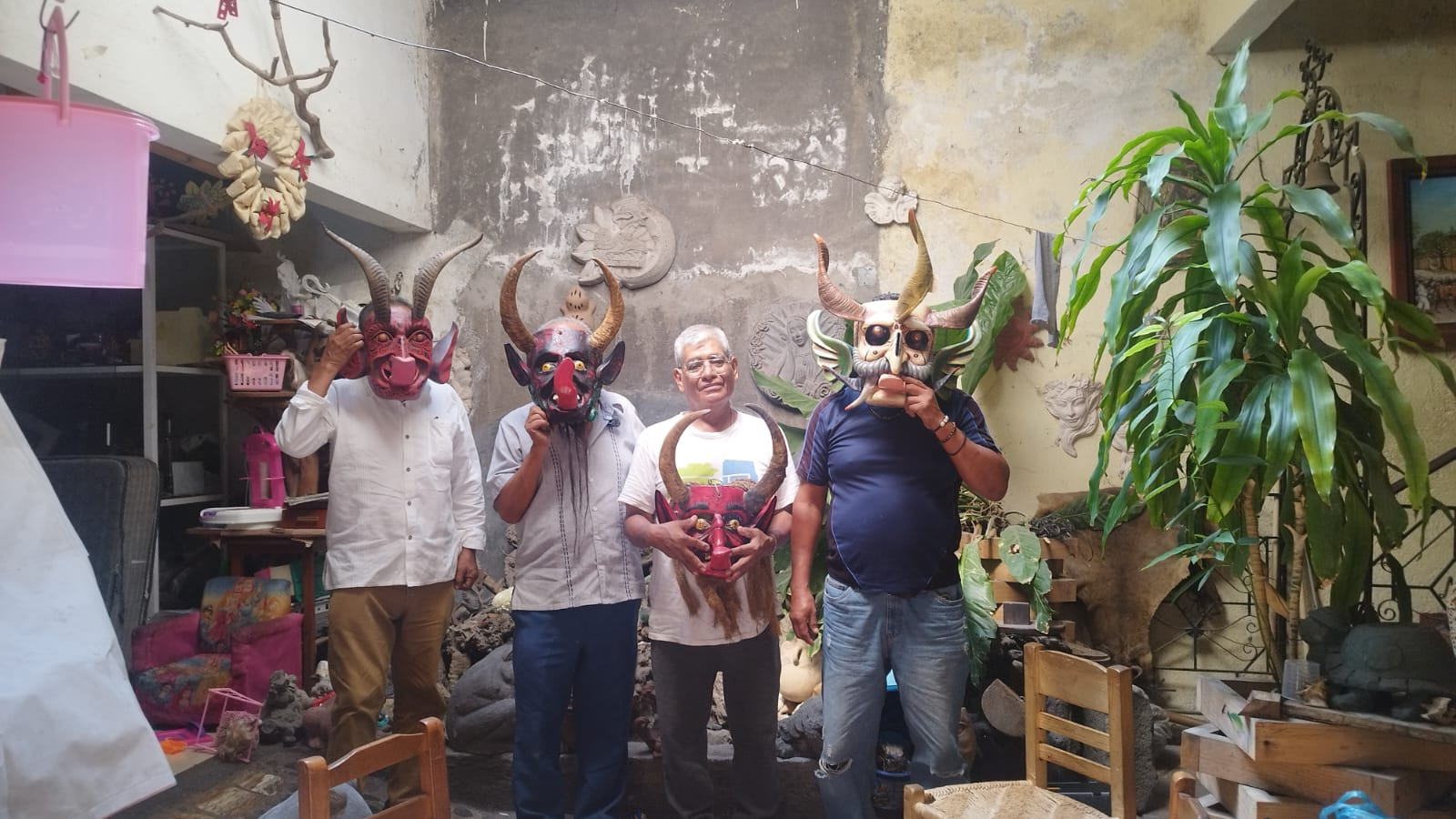 Personas con máscaras artesanales en un taller