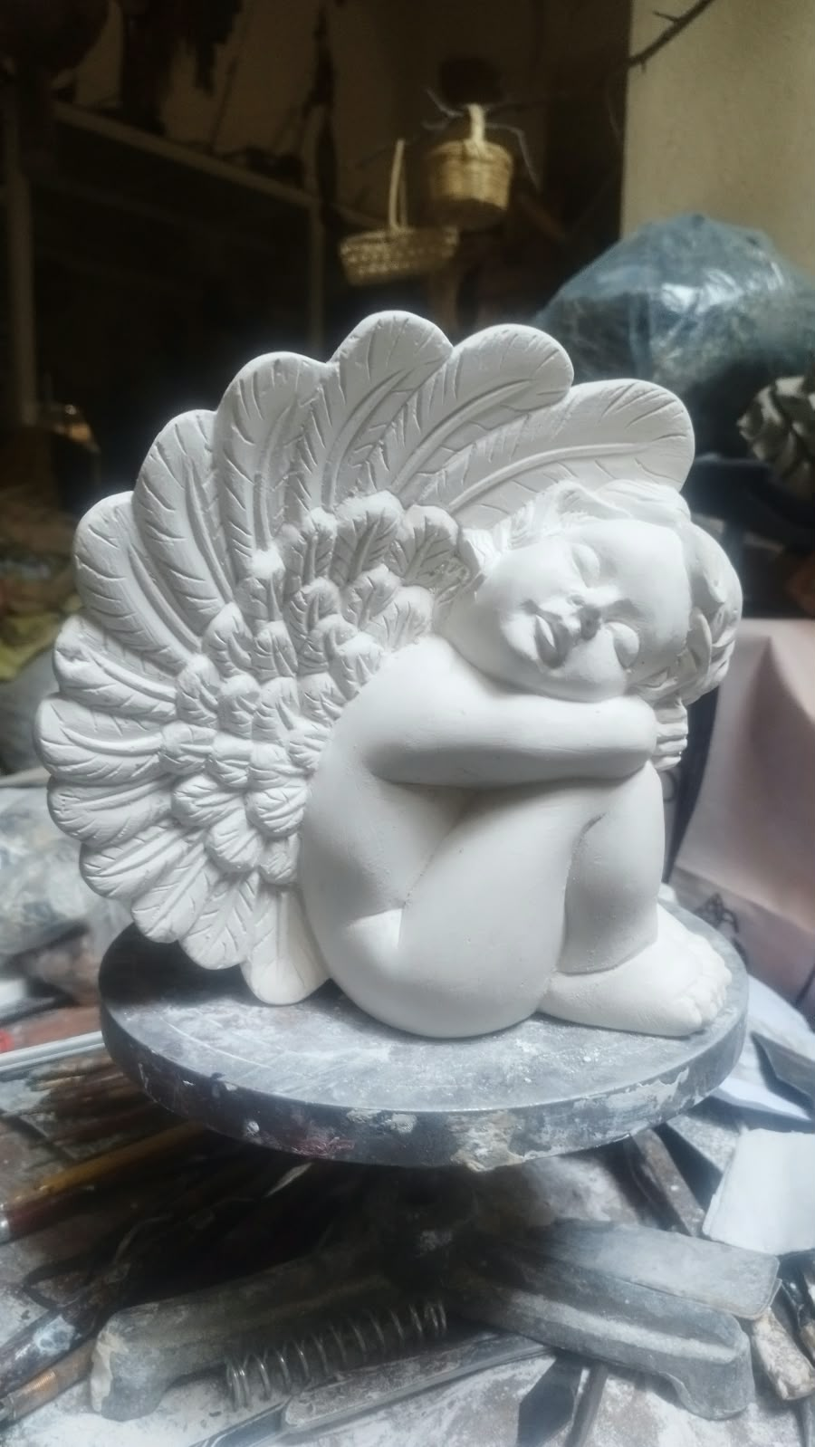 Escultura blanca de una figura con alas